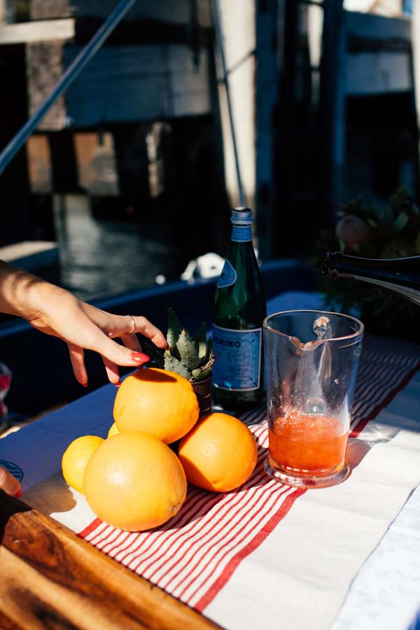 Woman hand with oranges and drink