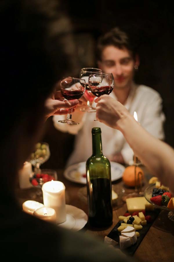 Young People Cheering With Red Wine