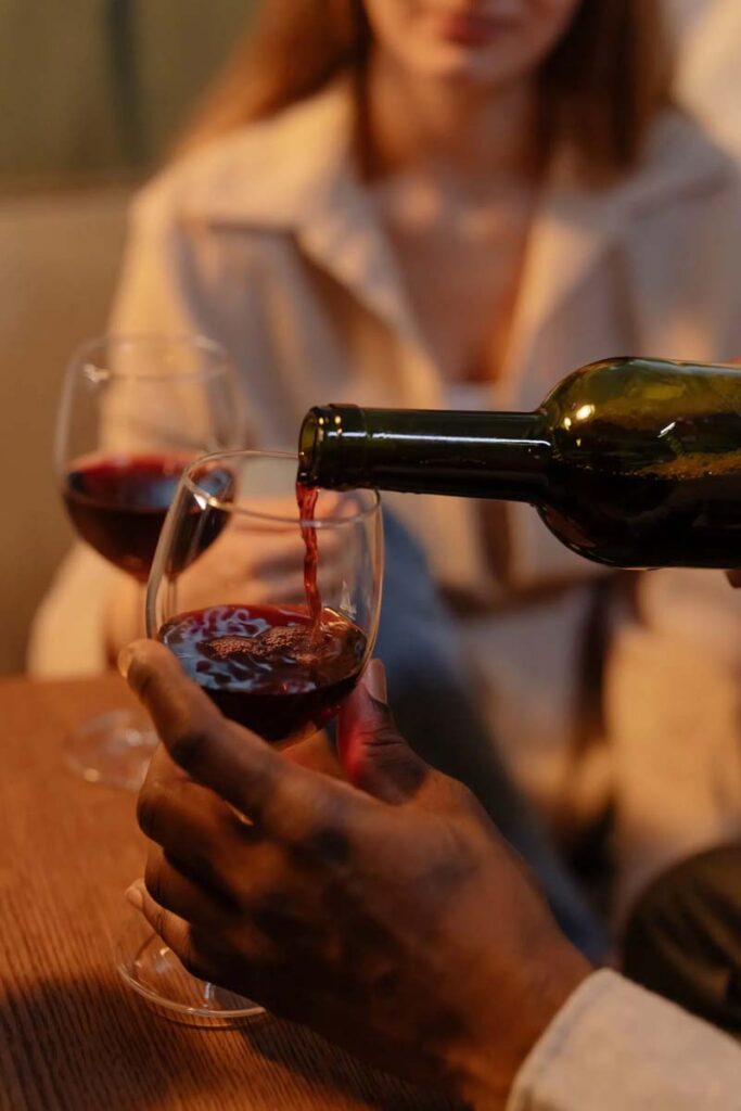 Man pouring red wine from a bottle